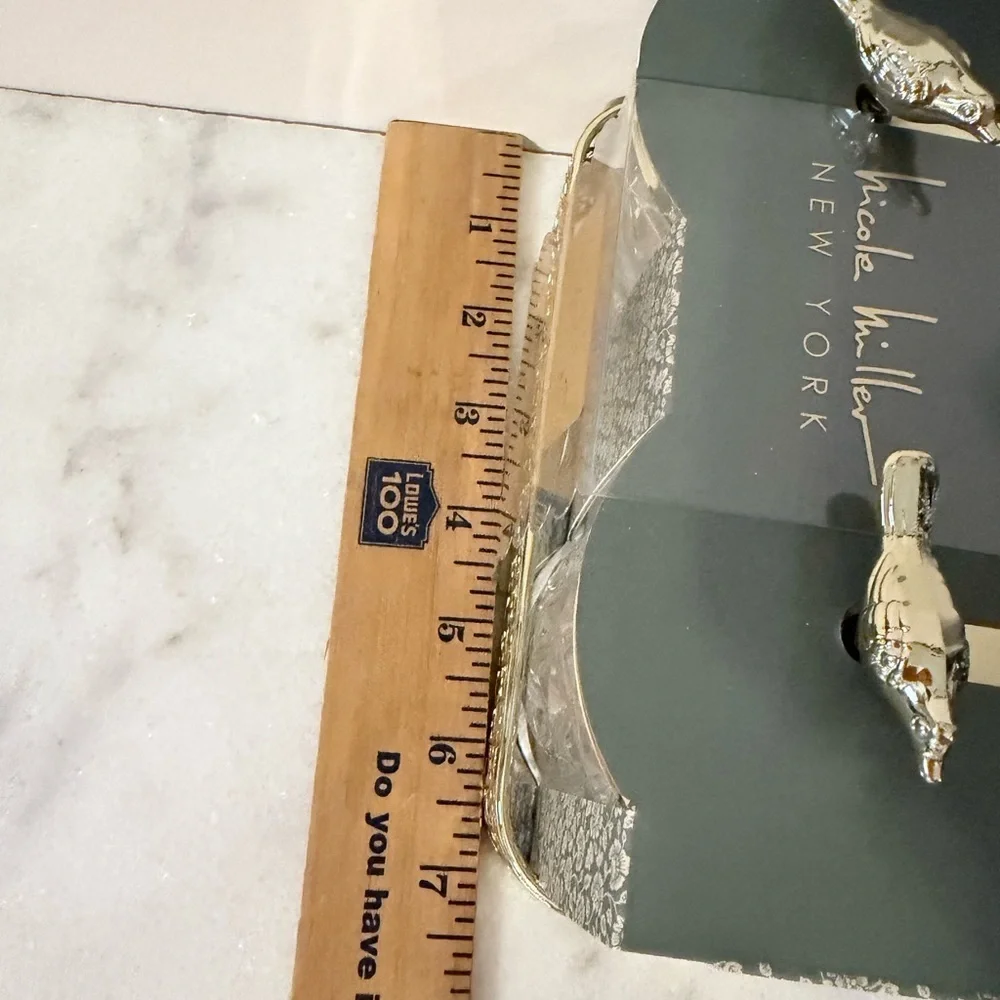 two-piece glass storage jar set with a gold bird lid and decorative tray.